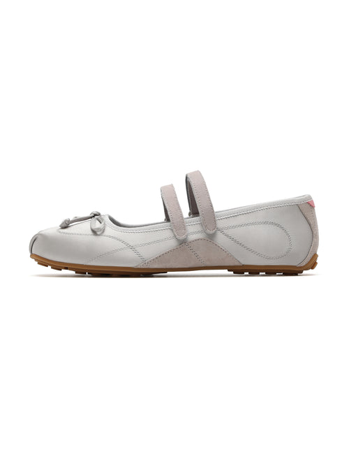 A light gray leather ballet flat shoe with double straps and a small bow detail on the toe, shown in profile against a white background.